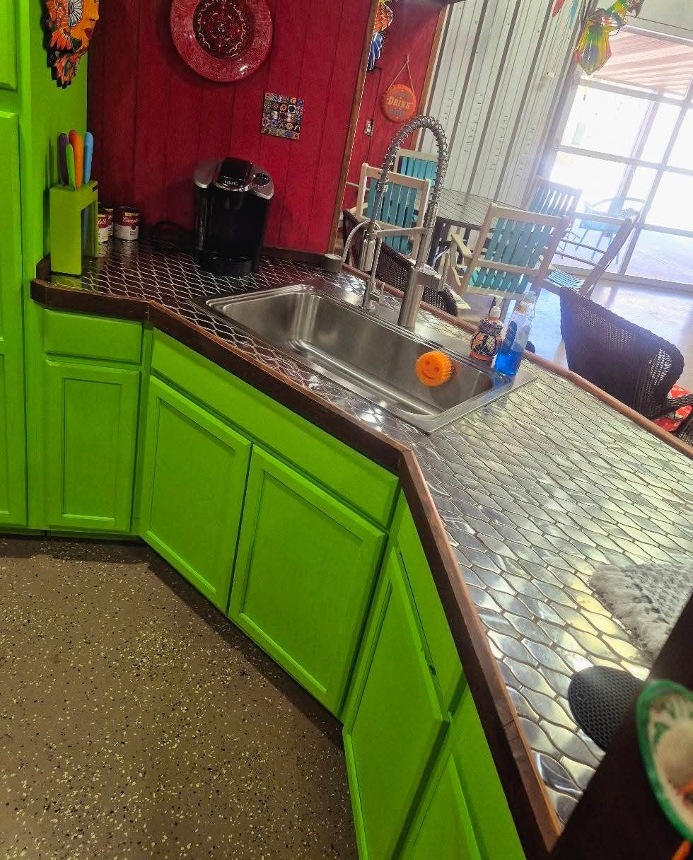 Colorful kitchen with bright green cabinets cleaned by Redeemed Cleaning Services